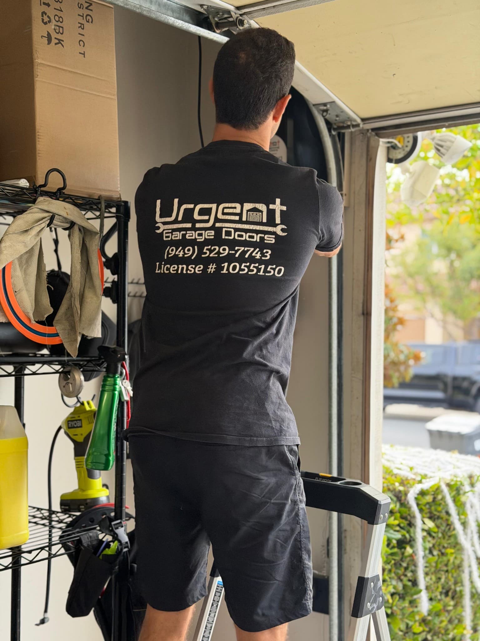 Urgent Garage Doors technician working on a garage door in Orange County